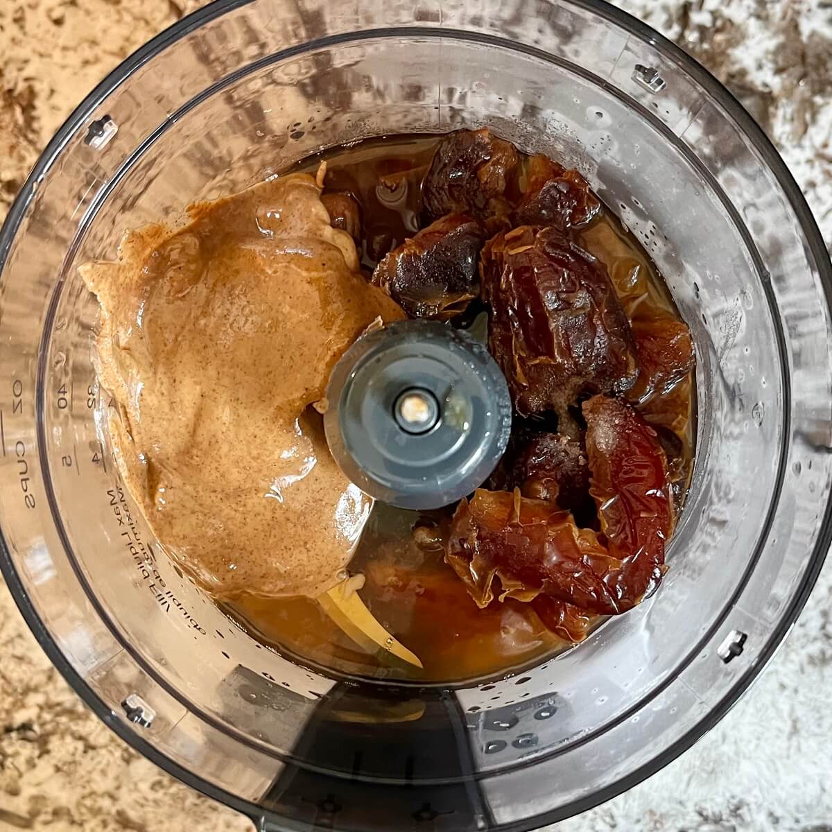 Ingredients for caramel sauce in a food processor.