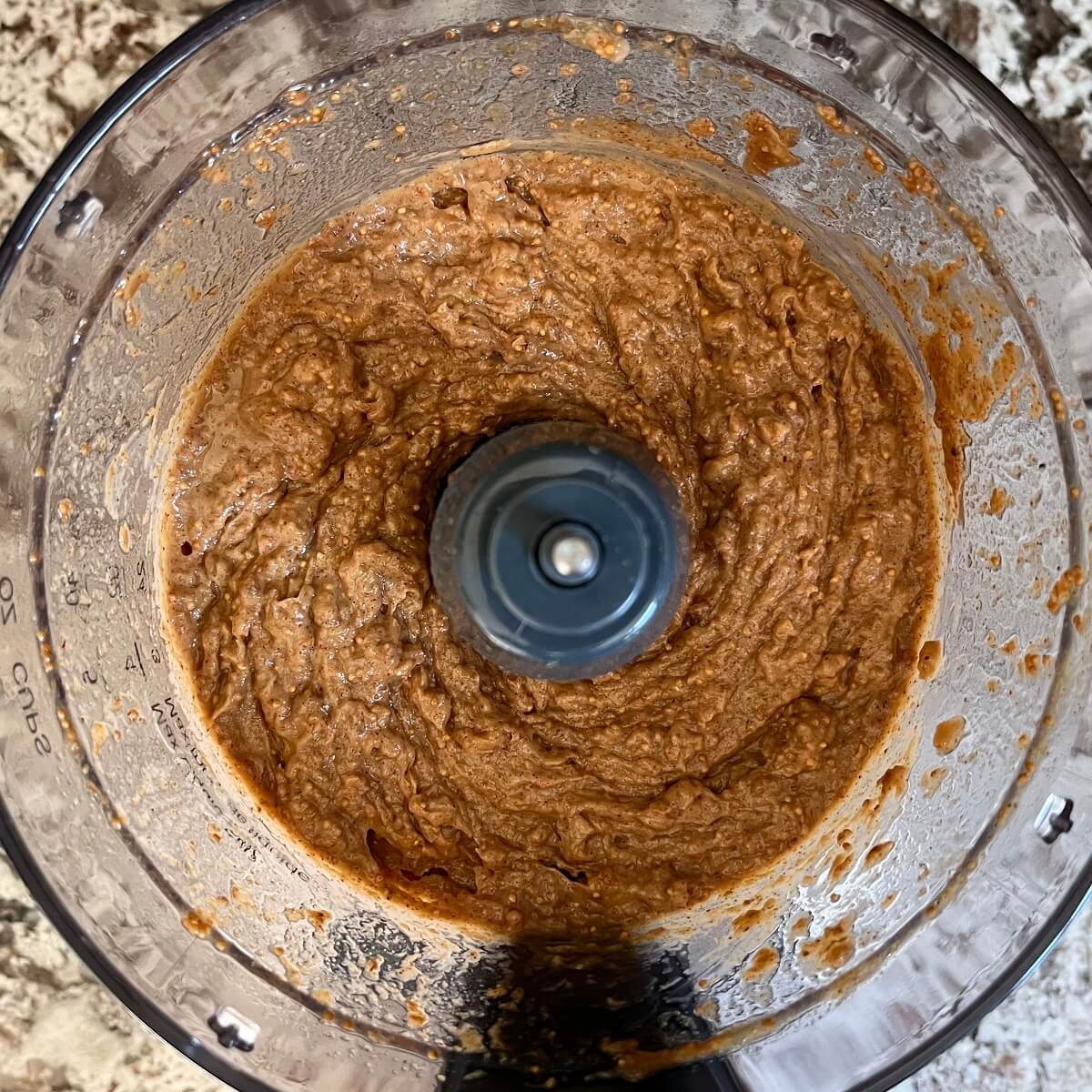 Blended fig mixture in a food processor.