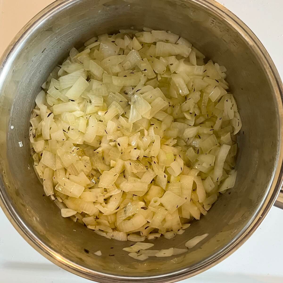 Cooked chopped onions in a pot.