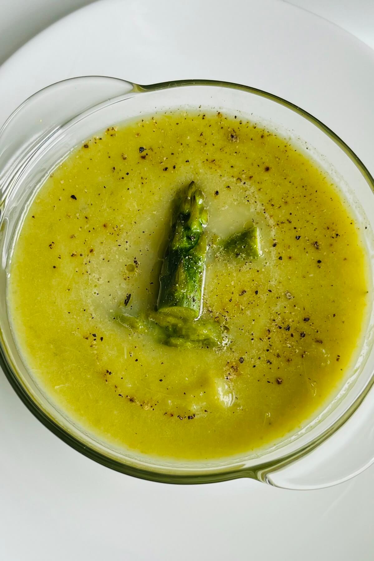 Vegan asparagus soup in a glass bowl.