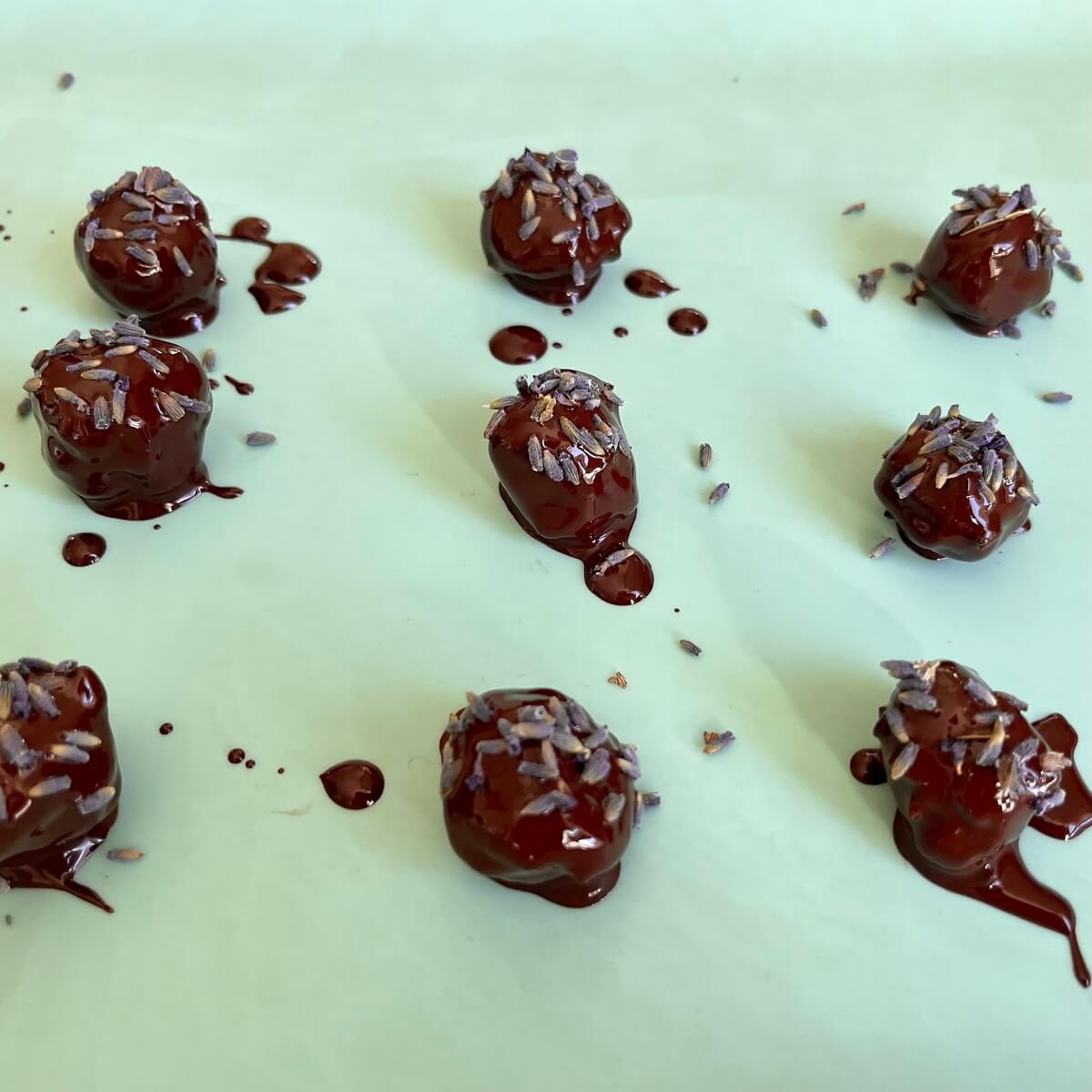Chocolate lavender balls on a silicone baking mat.