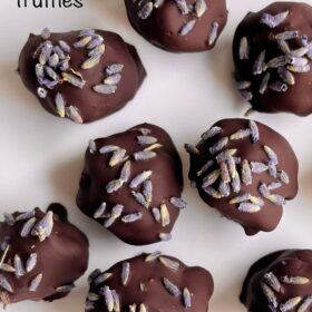 Lavender chocolate truffles on a white plate.