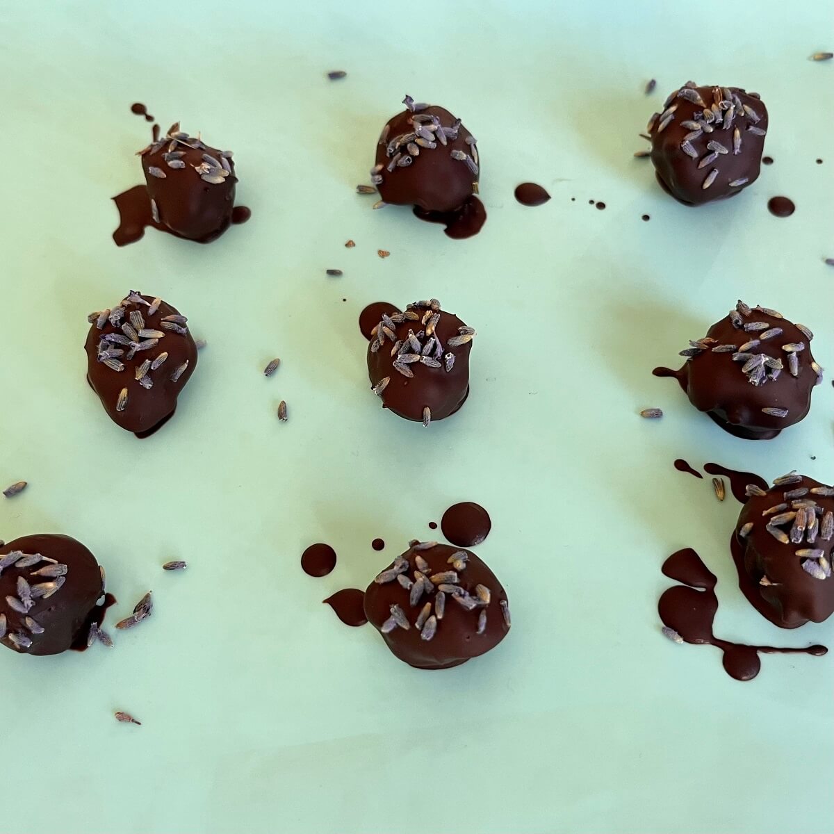 Lavender chocolates on a silicone baking mat.