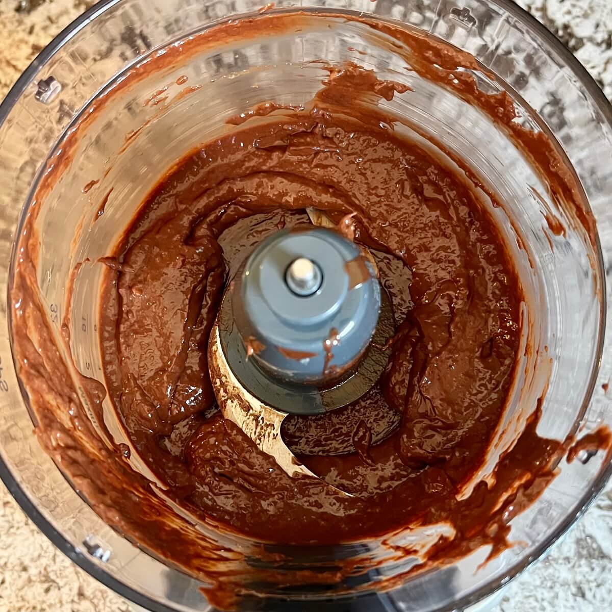 Mango chocolate mixture blended in a food processor.