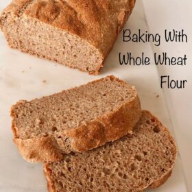Whole wheat flour loaf on a marble cutting board.