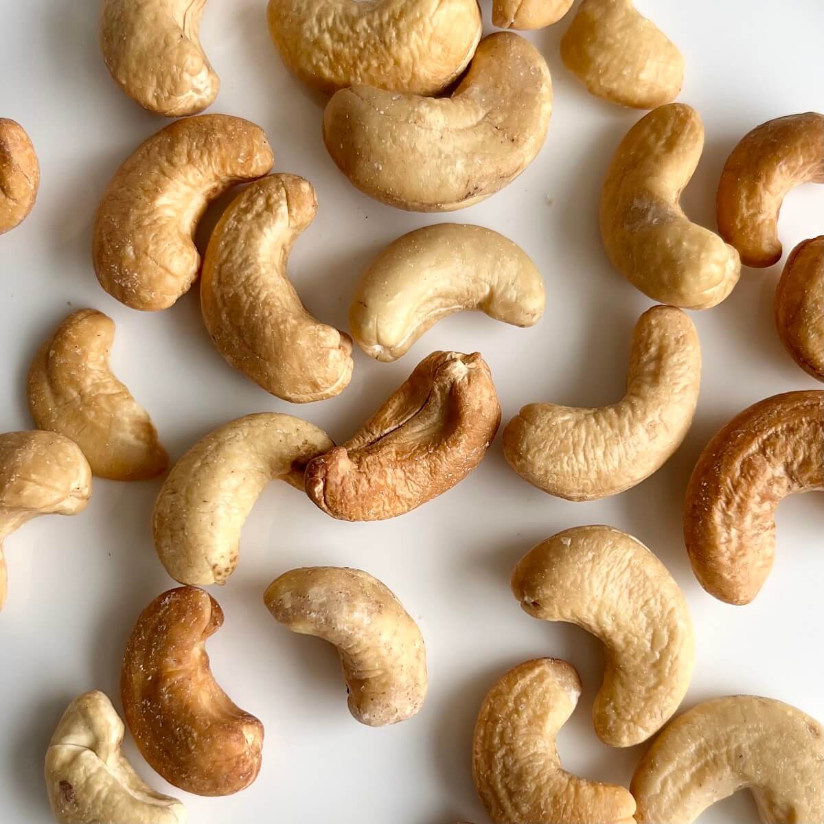 Cashews on a white plate.