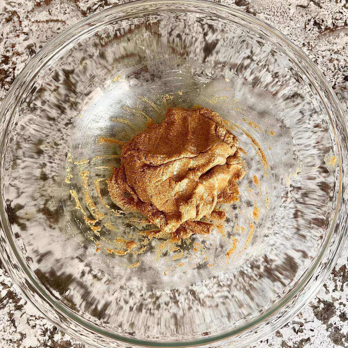 Corn flour cookie dough in a glass mixing bowl.