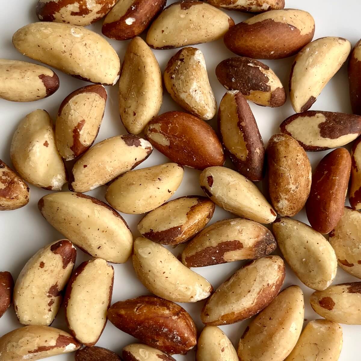 Selenium-rich brazil nuts on a white plate.