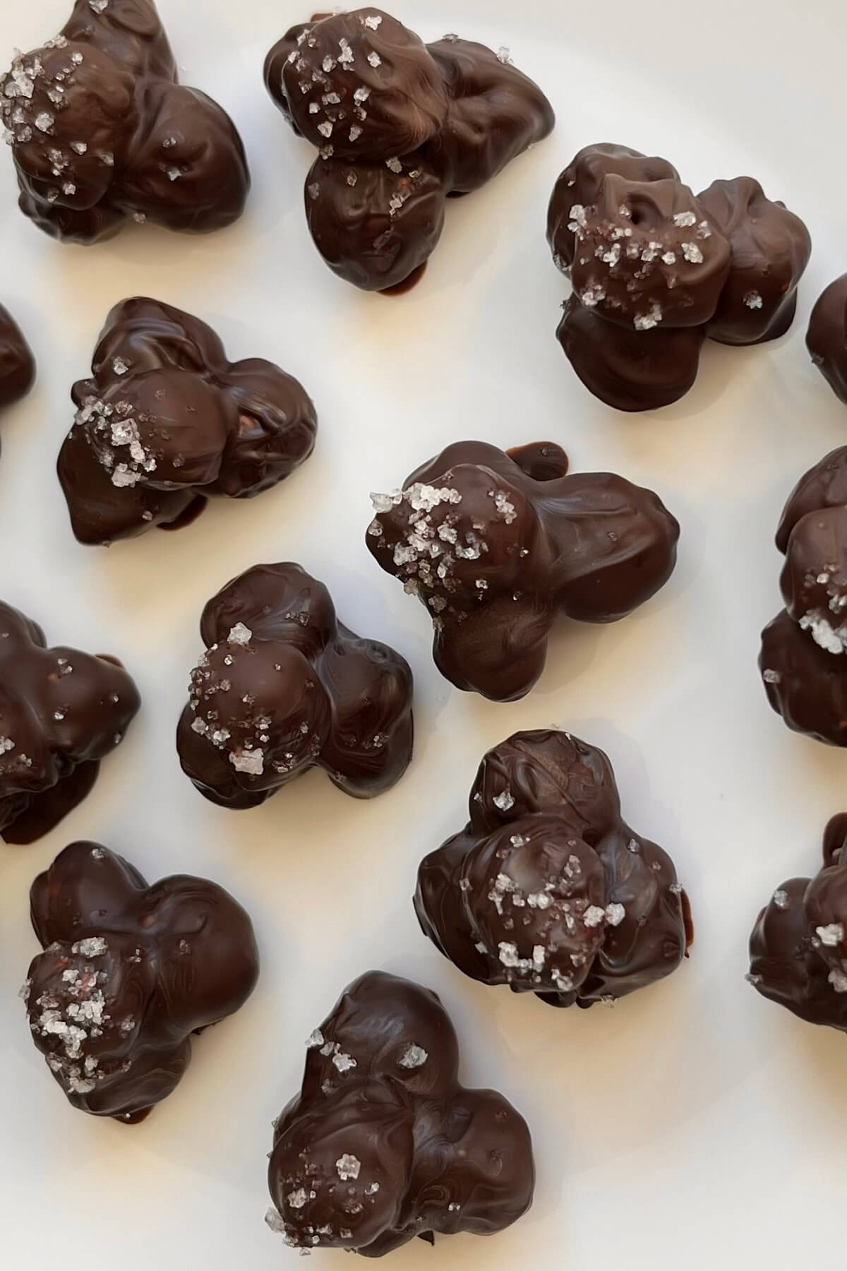 Chocolate hazelnut clusters on a white plate.