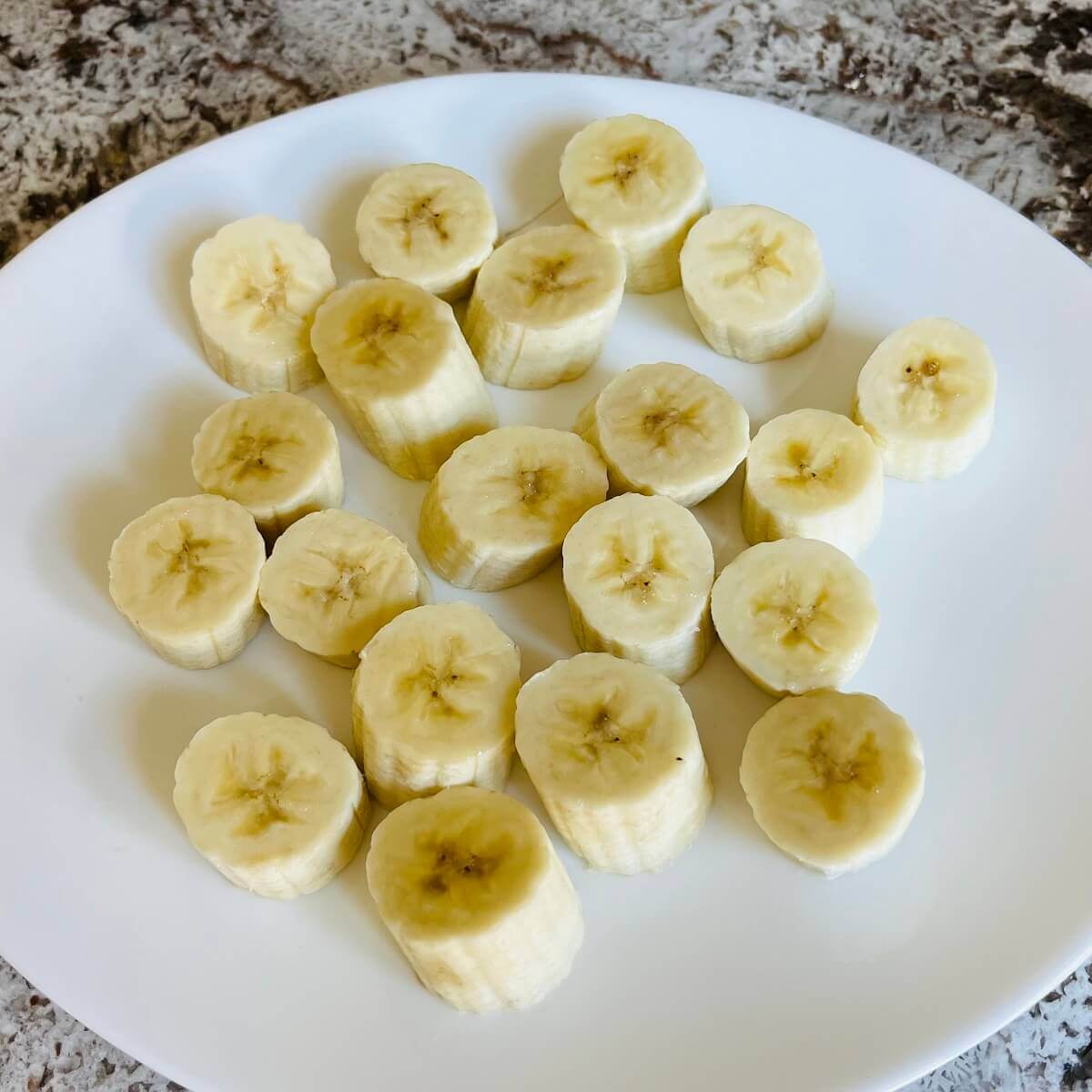 Banana slices on a white plate.