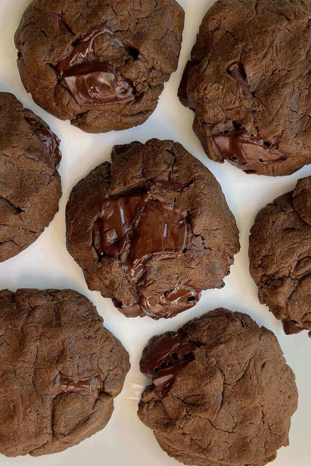 Chocolate protein cookies on a white plate.