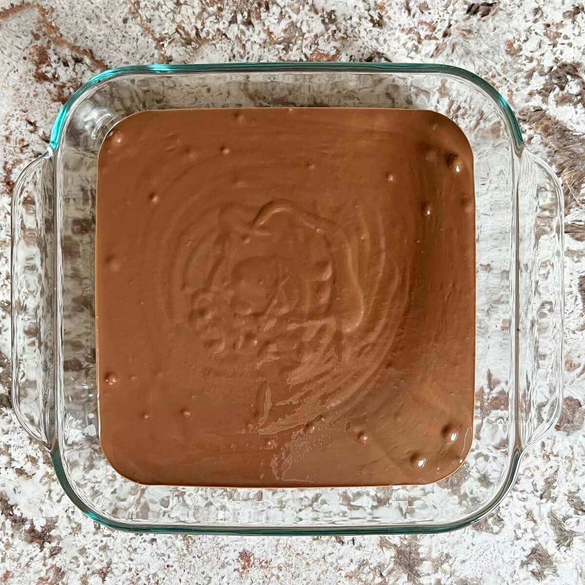 Chocolate mousse in a square glass baking dish.