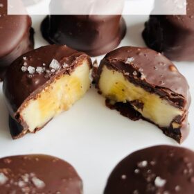 Chocolate covered banana slices on a white plate.