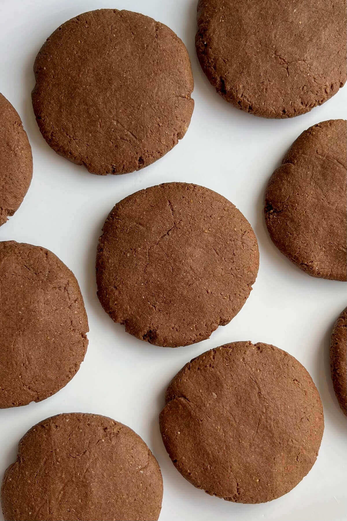 Cookies made with carob powder on a white plate.