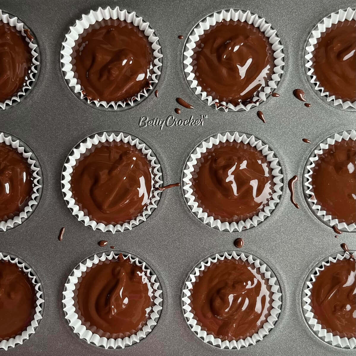 Vegan mint truffle batter in a mini muffin pan.