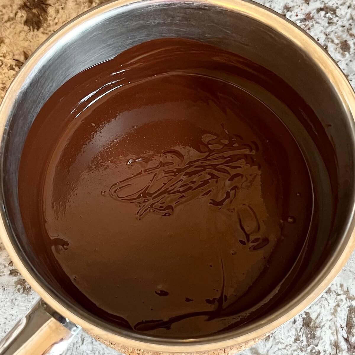 Wet ingredients for mint truffles in a steel pot.