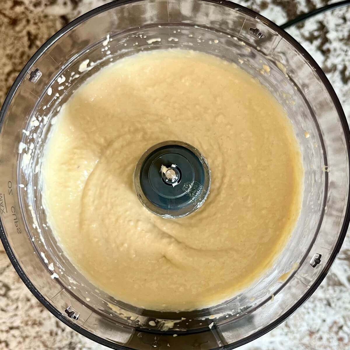 Blended hummus in a food processor.