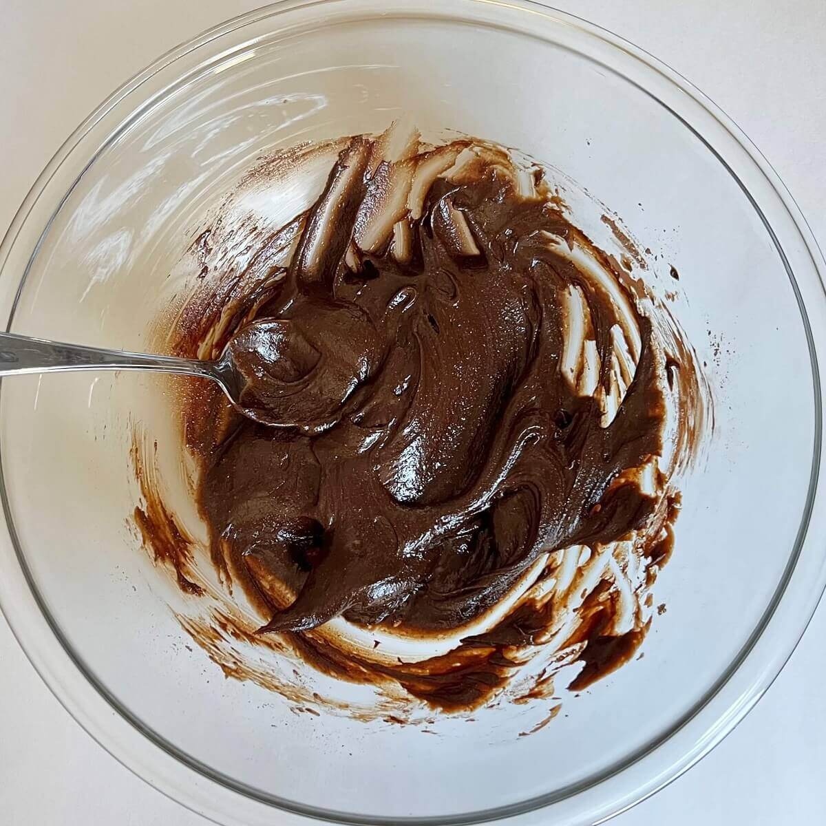 A mixture of carob powder and other ingredients in a glass bowl.