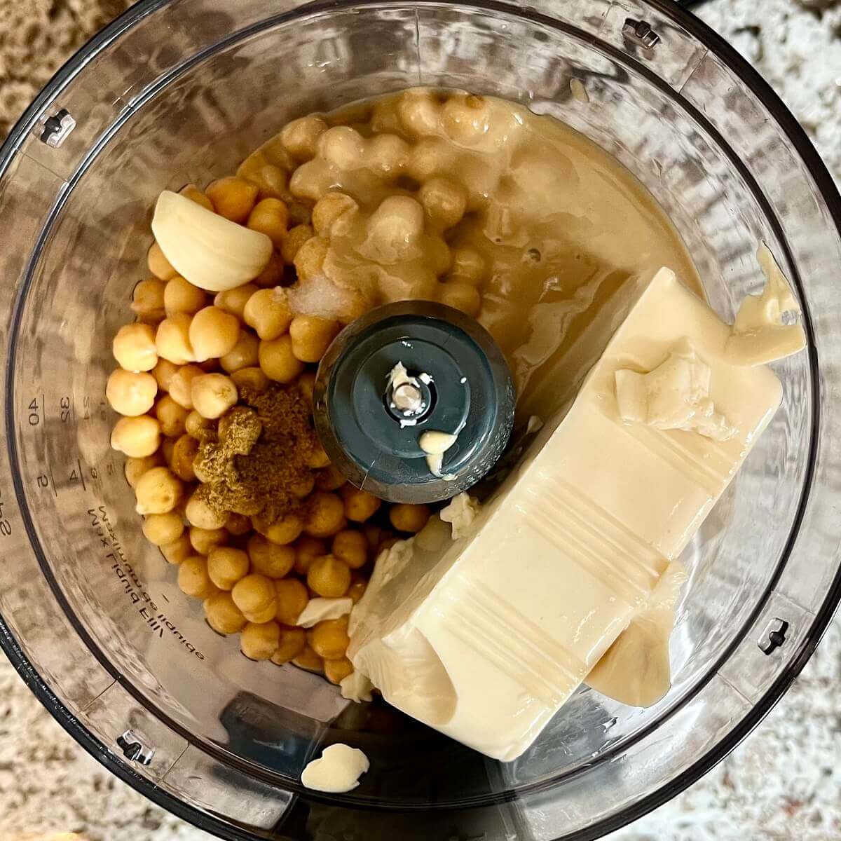Ingredients for hummus in a food processor.