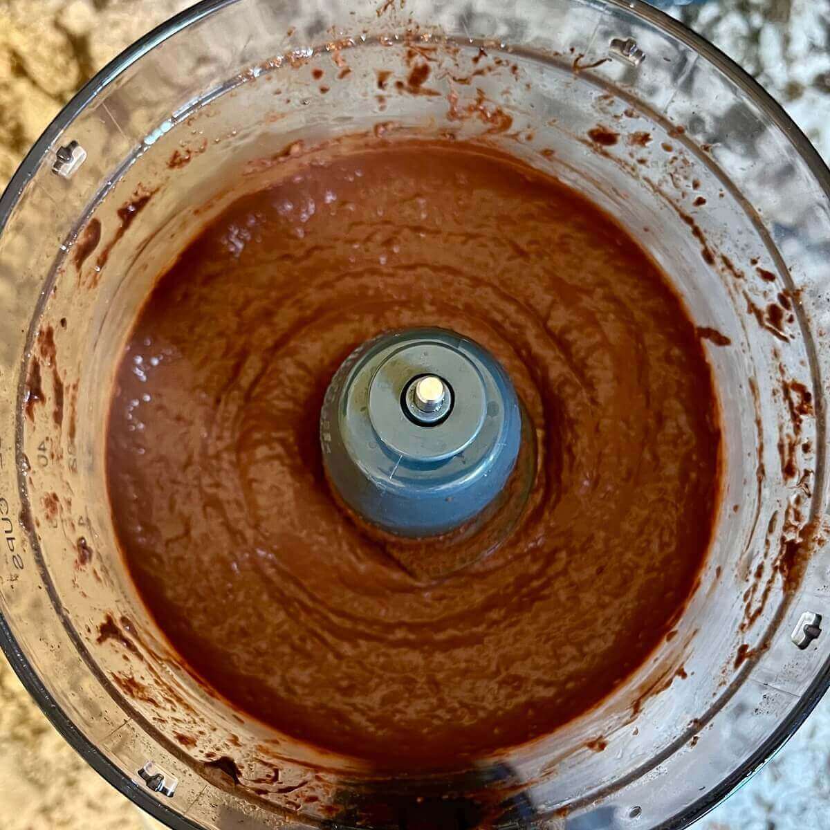 Blended chocolate raspberry mousse in a food processor.