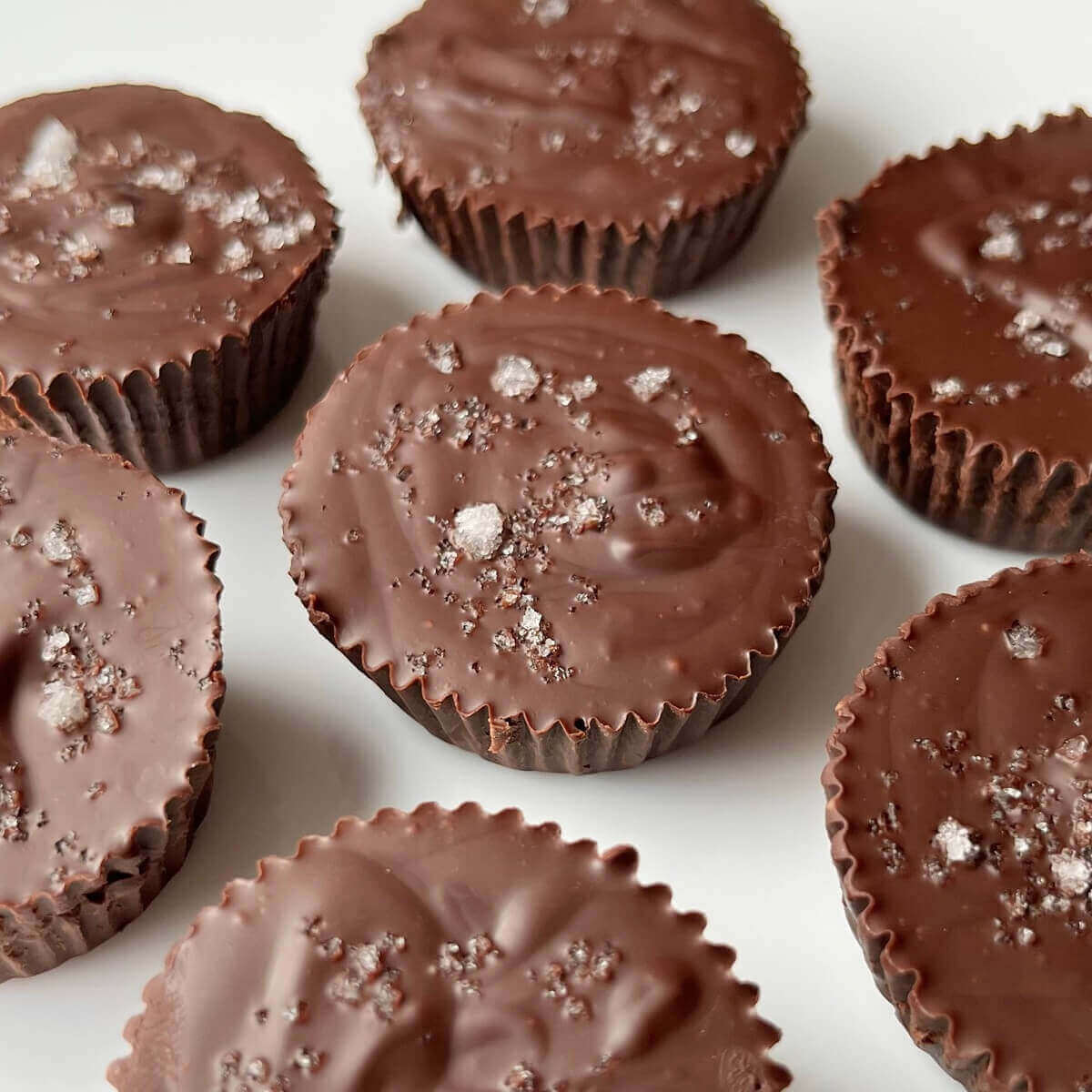 No-bake chocolate peanut butter cups on a white plate.