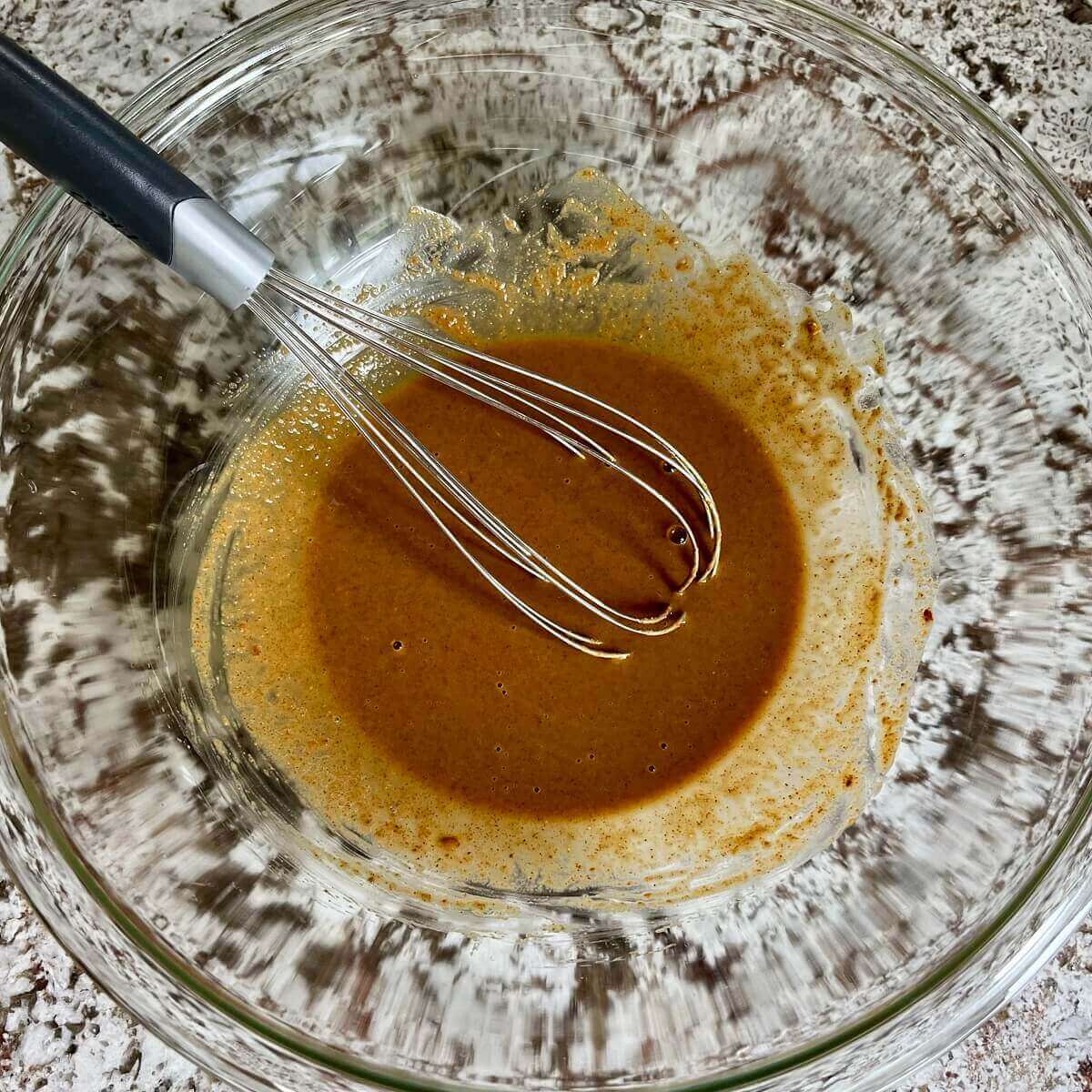 Almond butter sauce in a glass bowl.