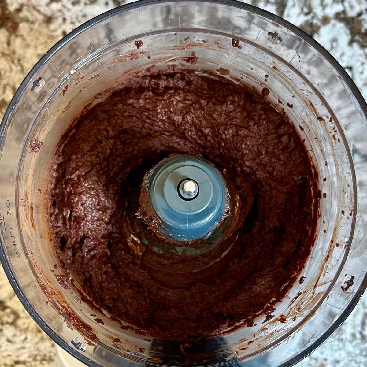 Blended ingredients for fudge in a food processor.