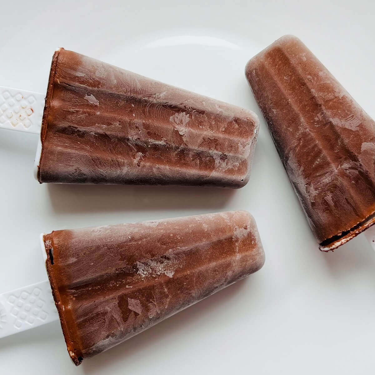 Popsicles on a white plate.