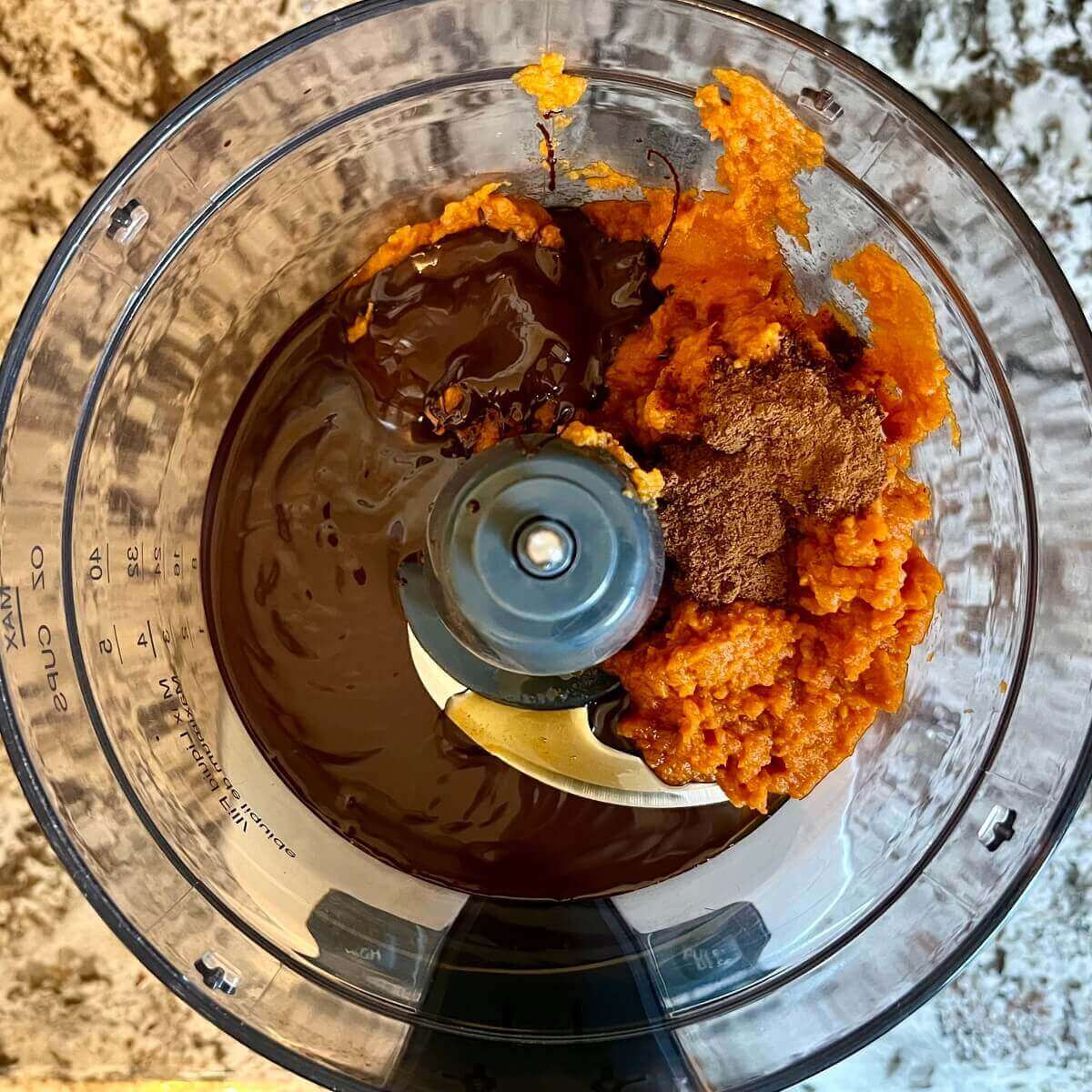 Ingredients for pumpkin mousse in a food processor.