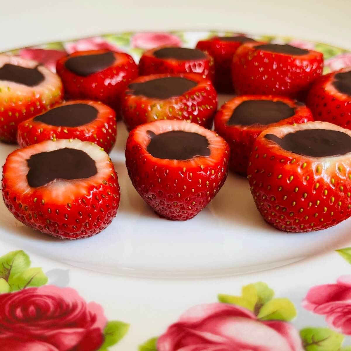 Chocolate filled strawberries on a white plate.