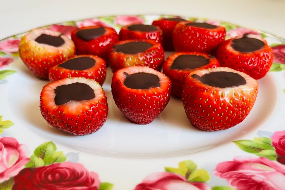 Chocolate strawberry treats on a floral plate.