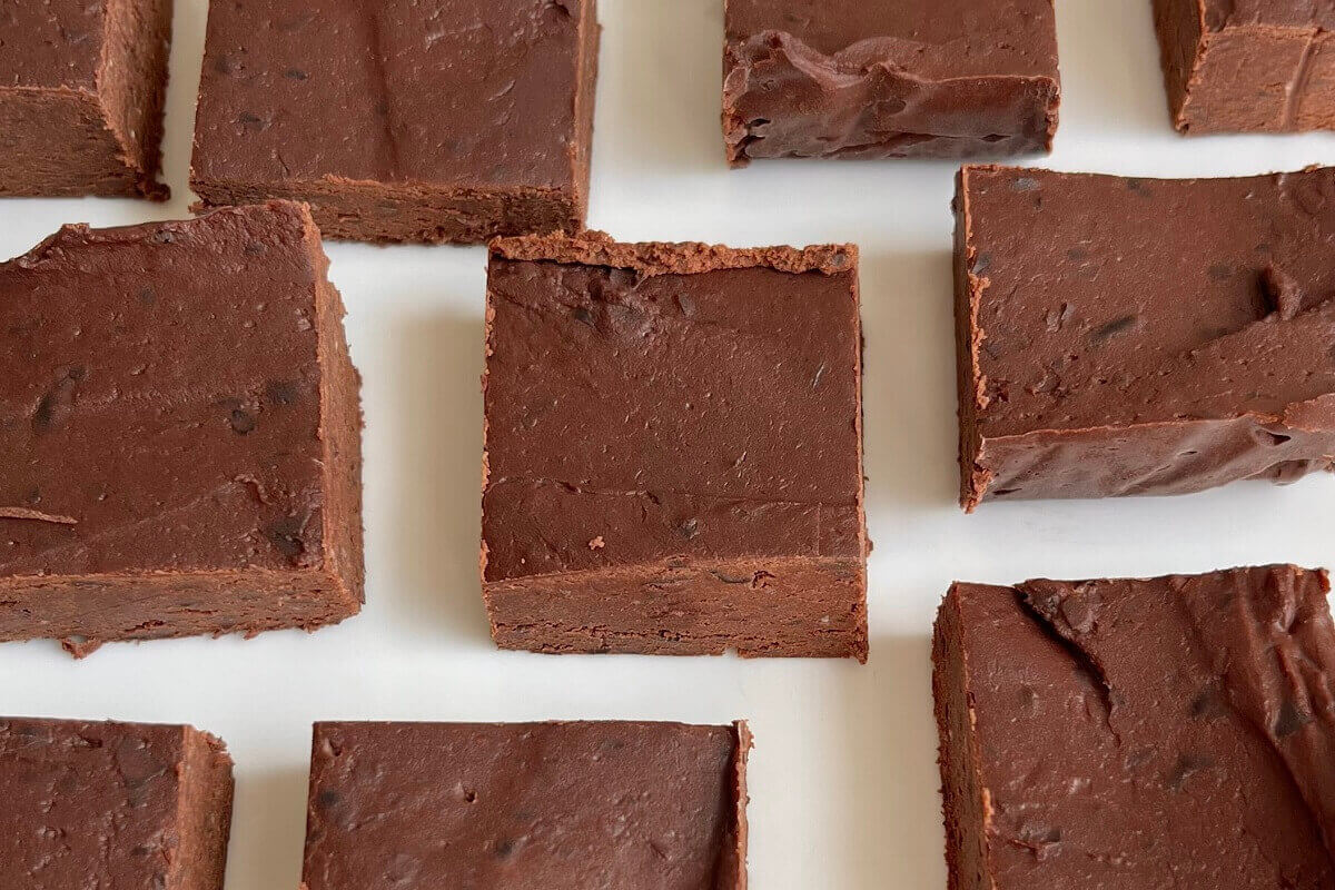 Fudge made with beans on a white plate.