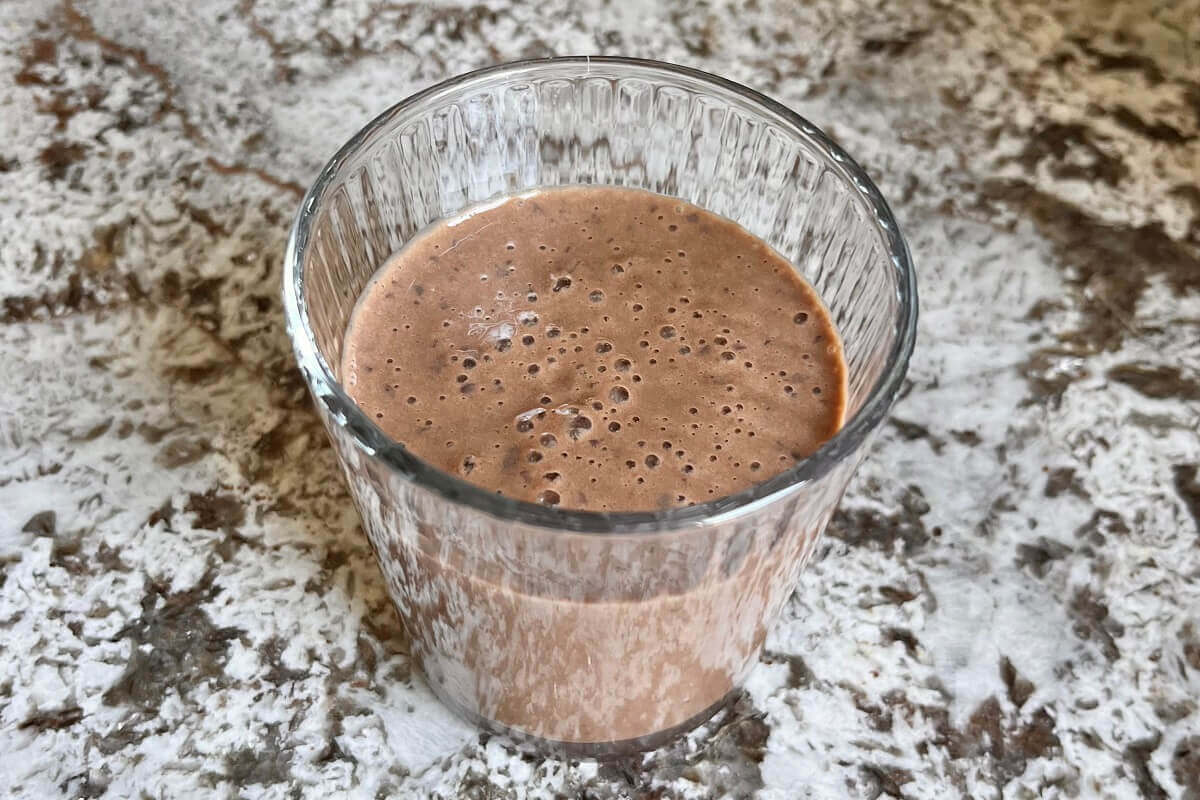 A smoothie made with black beans in a glass.