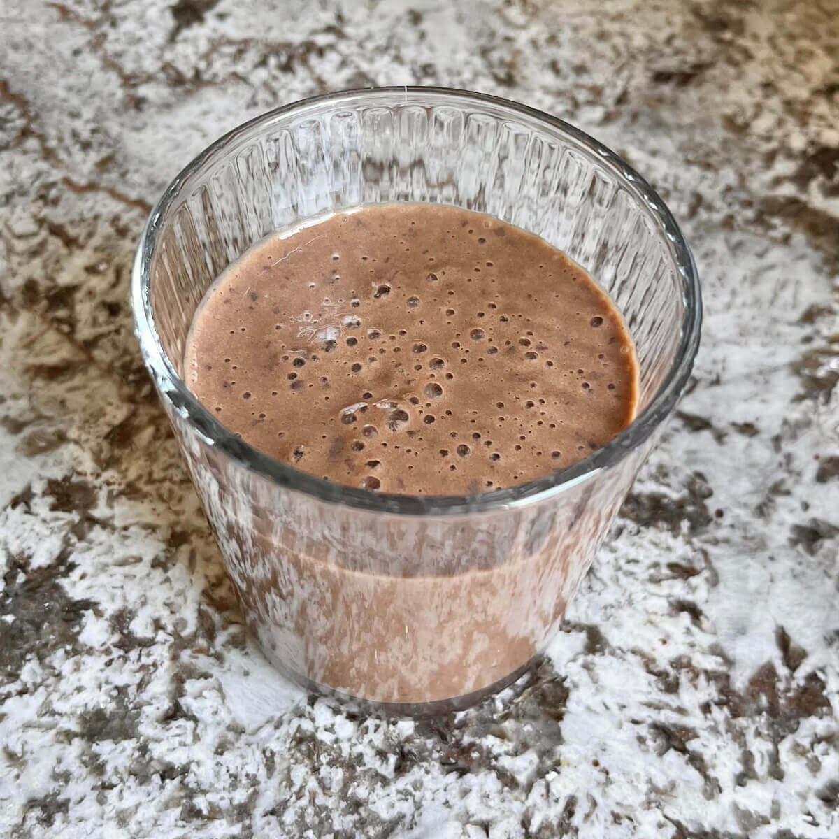 A black bean smoothie in a glass.