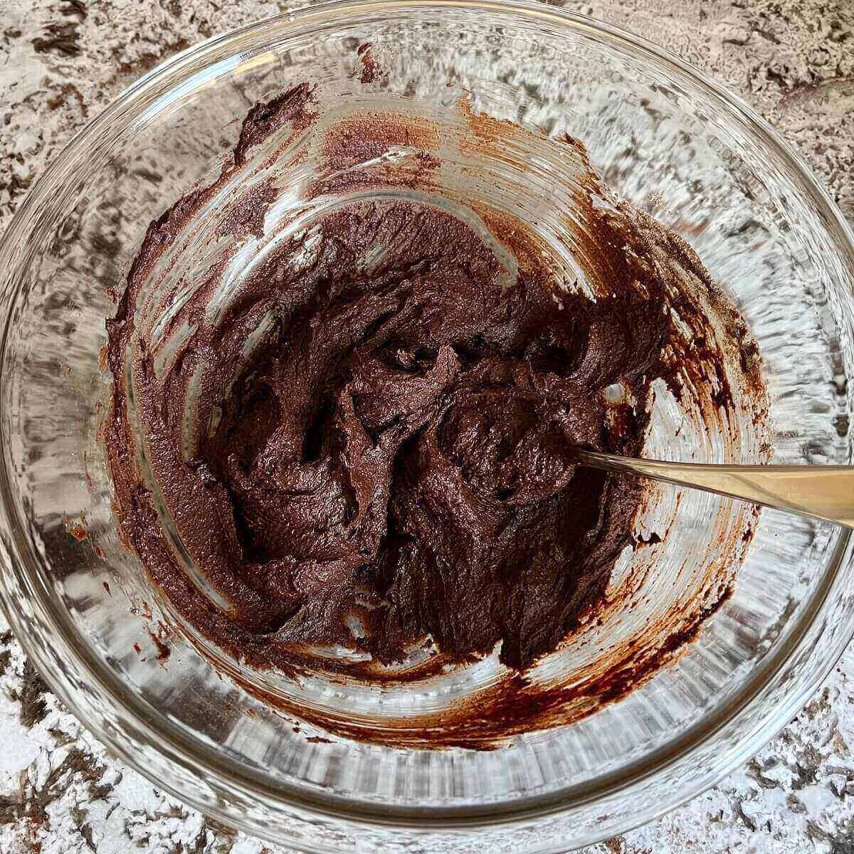 Buckwheat brownie batter in a glass mixing bowl.