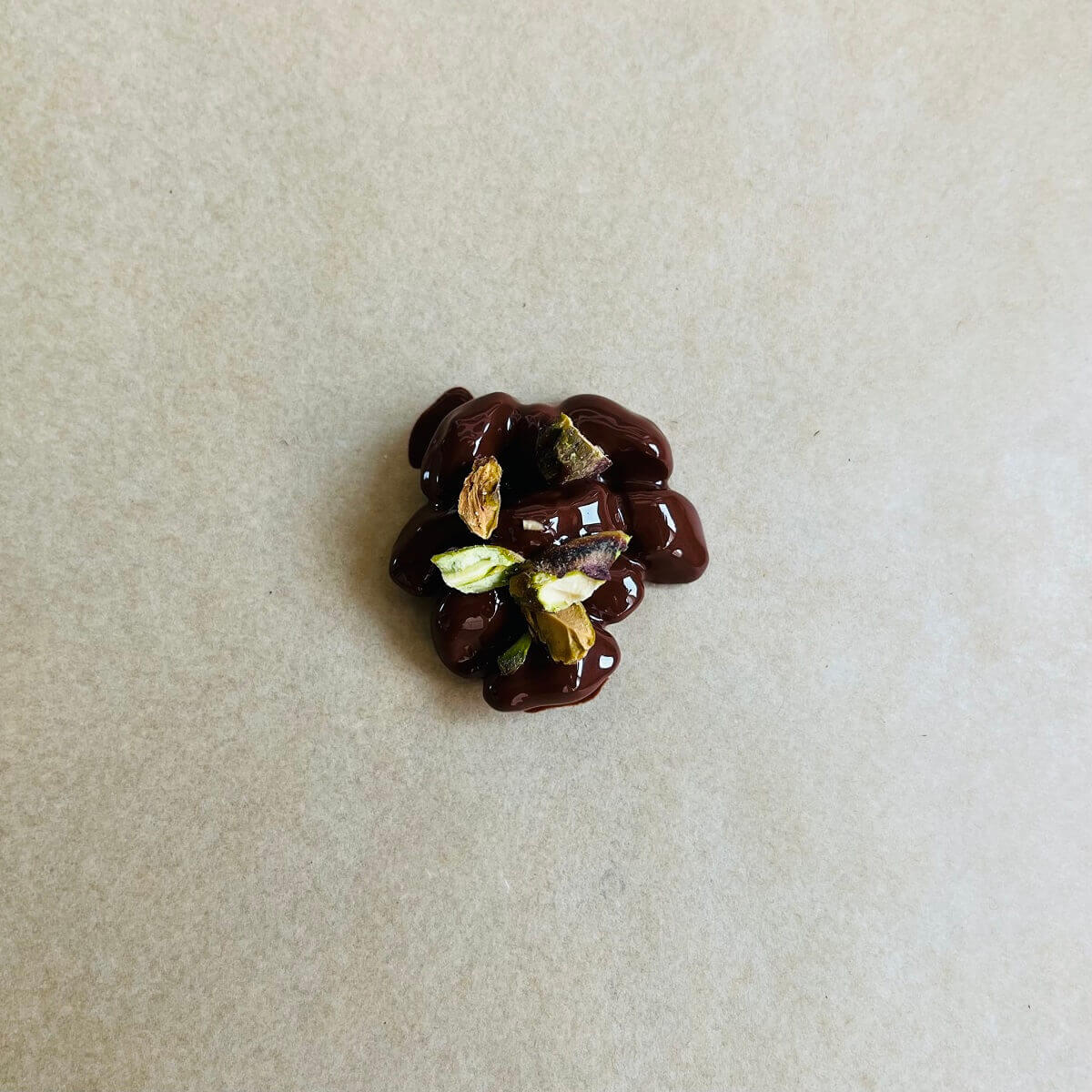 A cluster of pistachios covered in melted chocolate.