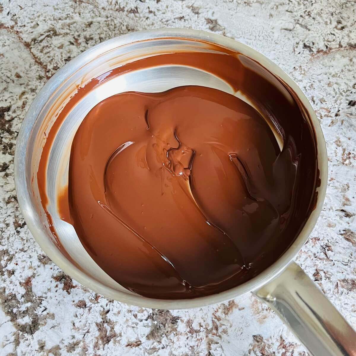 Warm melted dark chocolate in a pan.