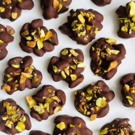 Pistachio clusters on a white plate.