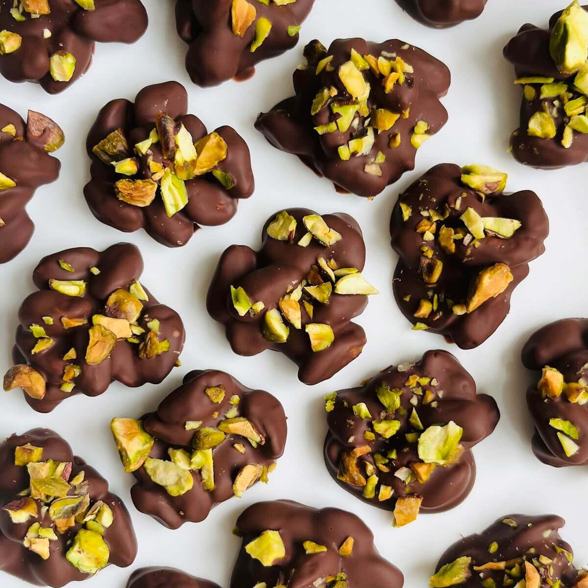 Pistachio clusters on a white plate.