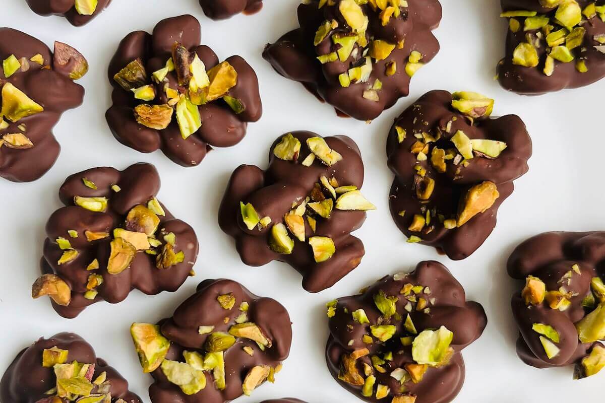 Pistachio chocolate treats on a white plate.