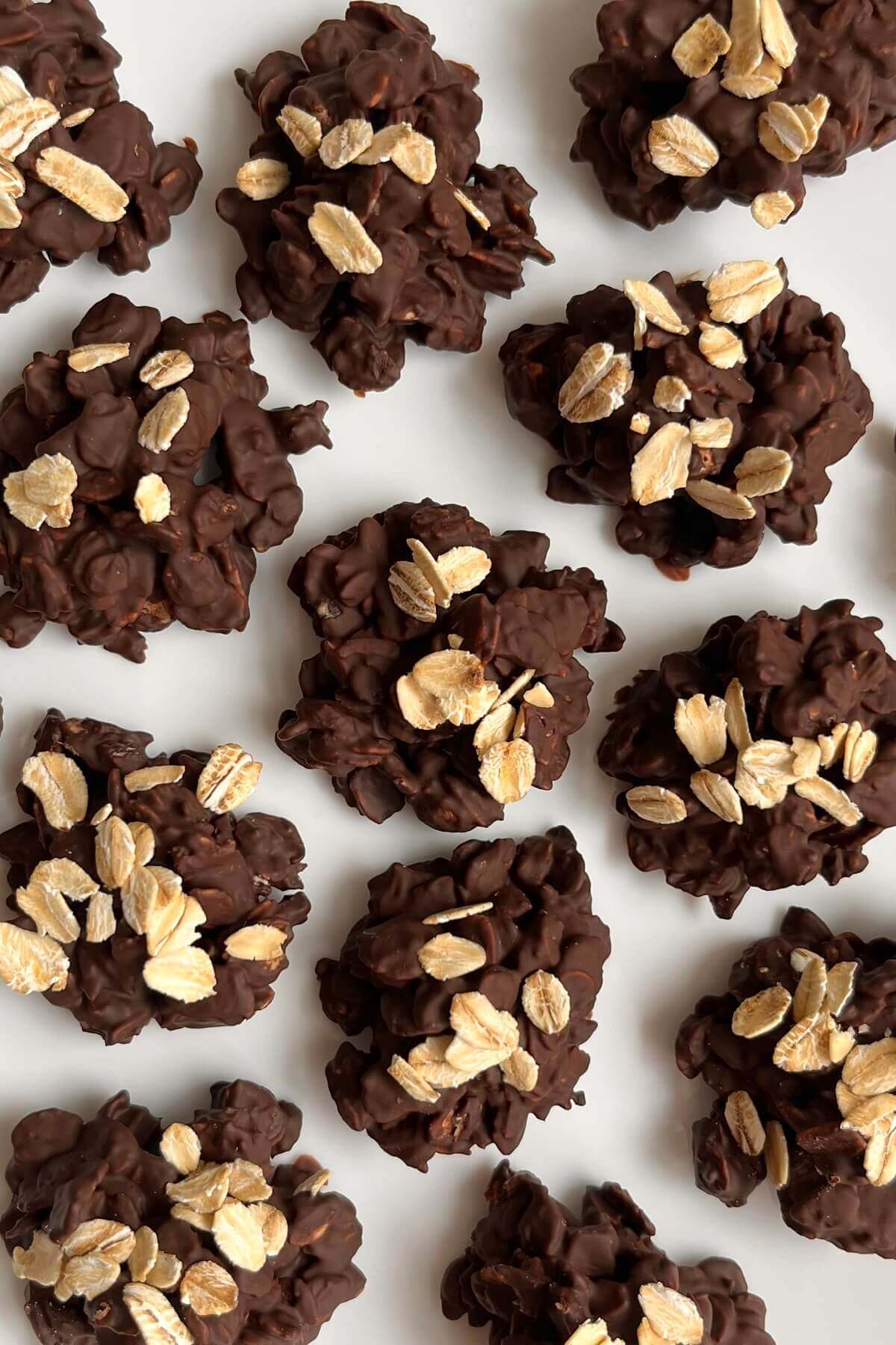 Eleven chocolate oat bites on a white plate.