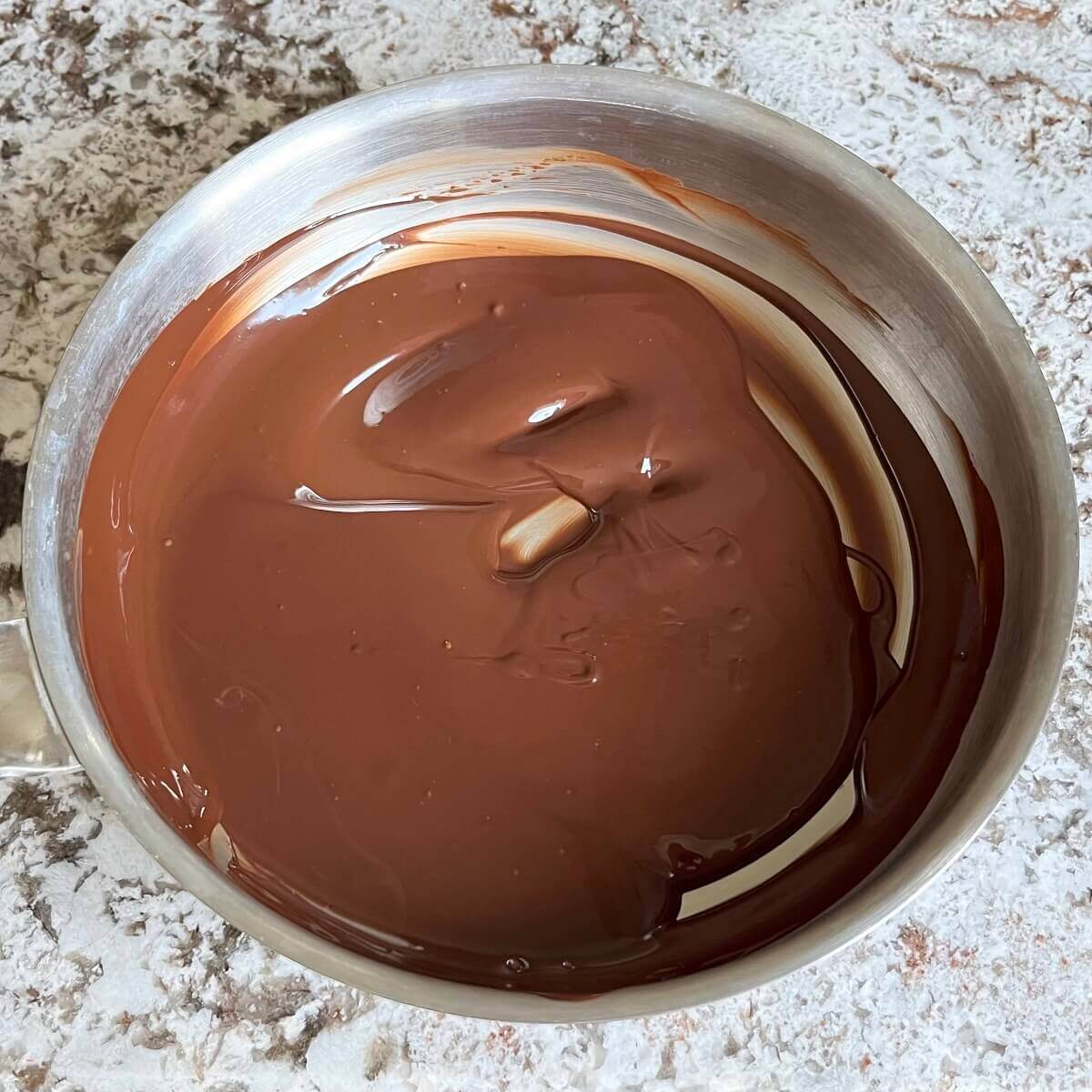 Melted dark chocolate in a pan.