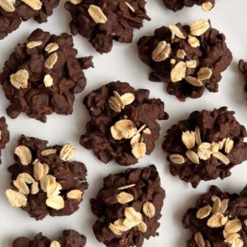 Chocolate oat clusters on a white plate.