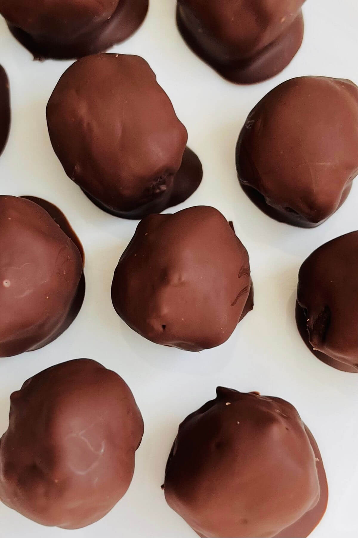 Coffee truffles on a white plate.