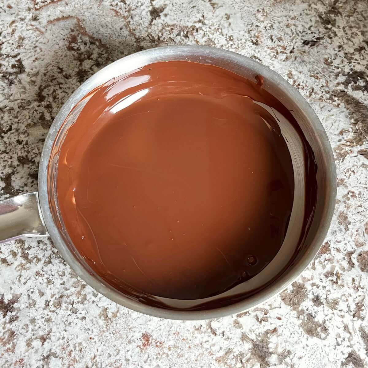 A pan of melted dark chocolate.