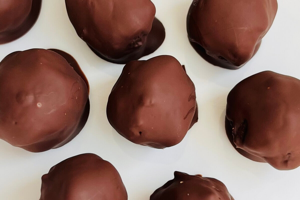 Mocha chocolates on a white plate.