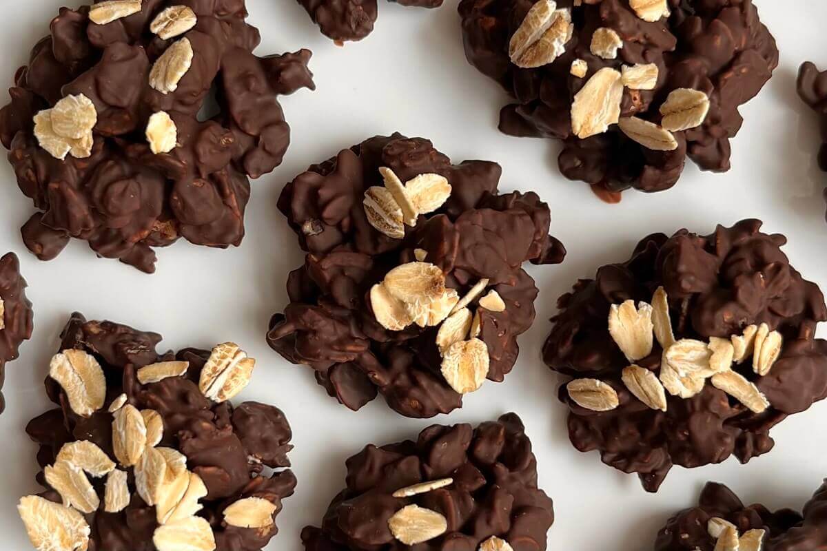 Oat and chocolate treats on a white plate.