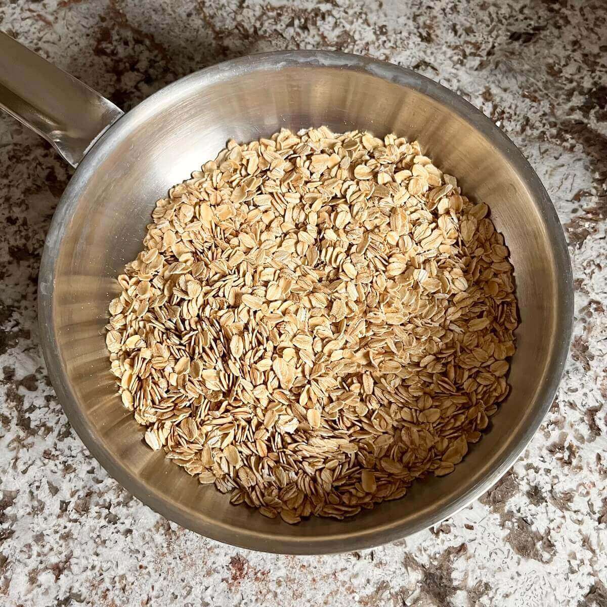 Toasted rolled oats in a steel pan.
