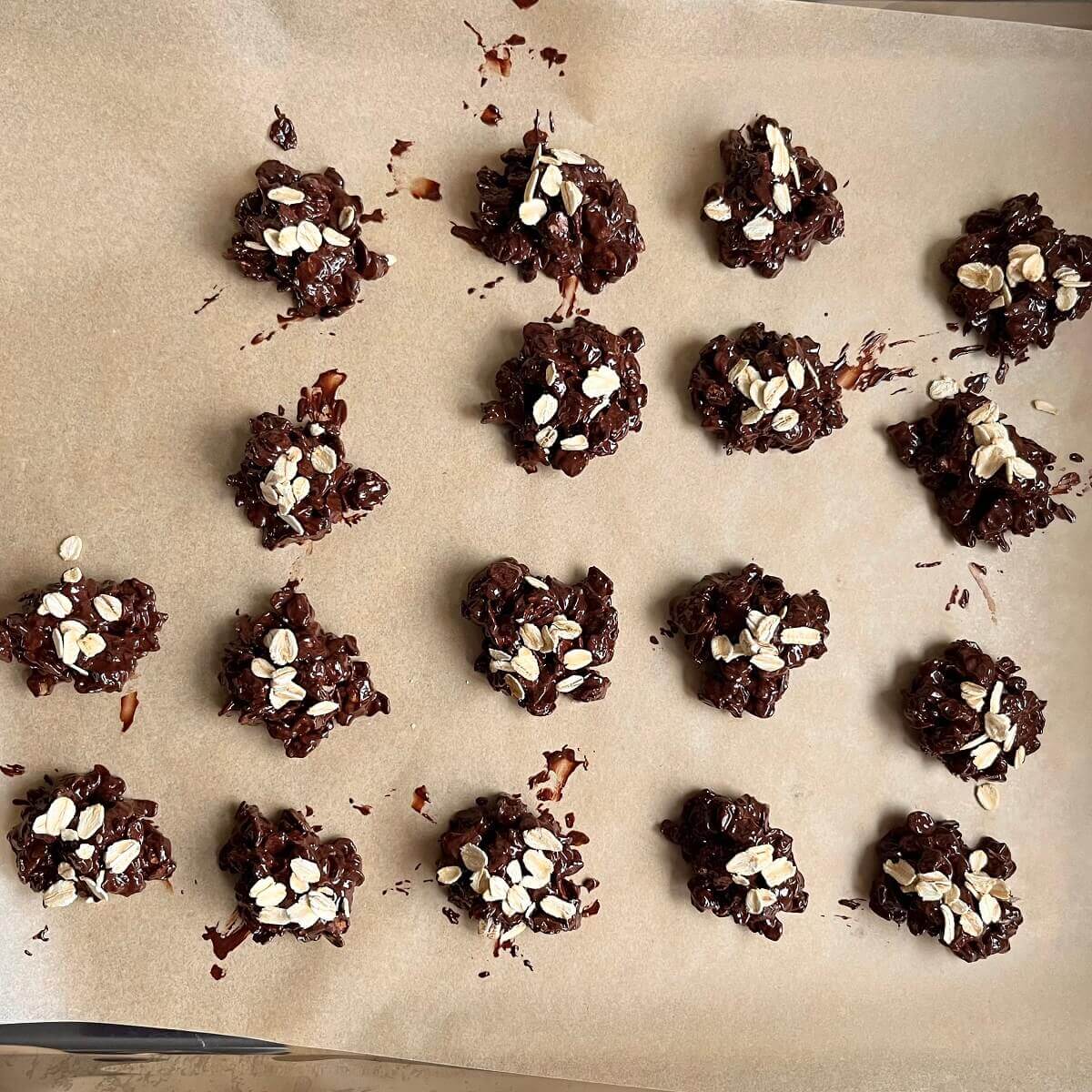 Chocolate clusters on a sheet pan lined with parchment paper.