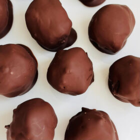 Vegan mocha truffles on a white plate.